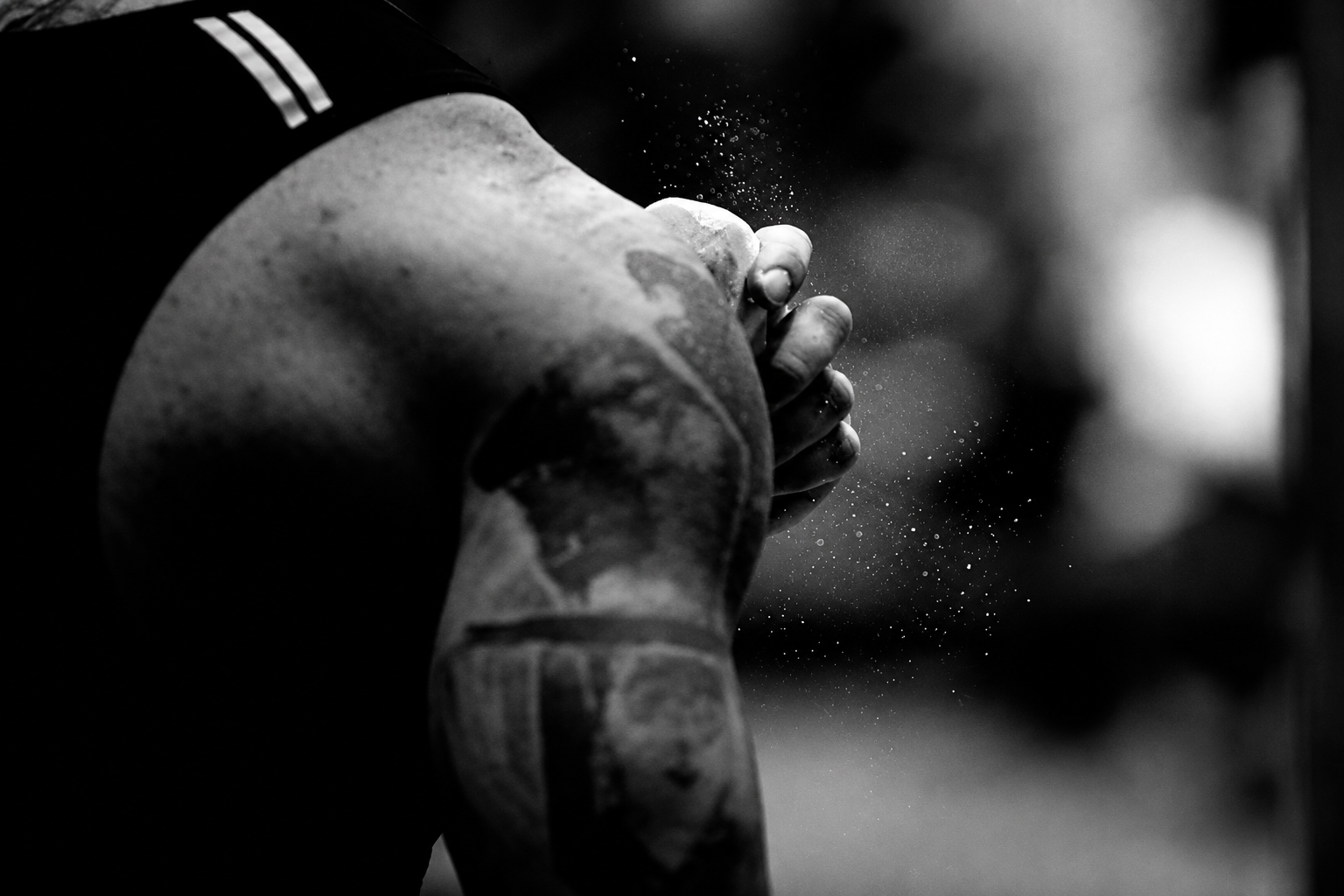 Athlete preparing chalked hands for a lift
